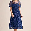 Lizzie Navy Puff Sleeve Midi Florals with Modern Volume by Trellis Lane mother of the bride dress on model