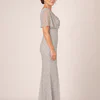Side view of the crystal silver beaded mermaid gown showing the cowl drape and flutter sleeve