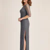 Side view of the charcoal pearl-beaded column gown showing the fitted pencil line and three-quarter sheer sleeve