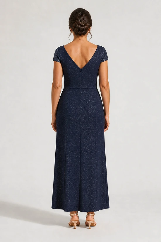 Back view of the Delphine navy twist-waist glitter knit gown by Dressology on a regular size model