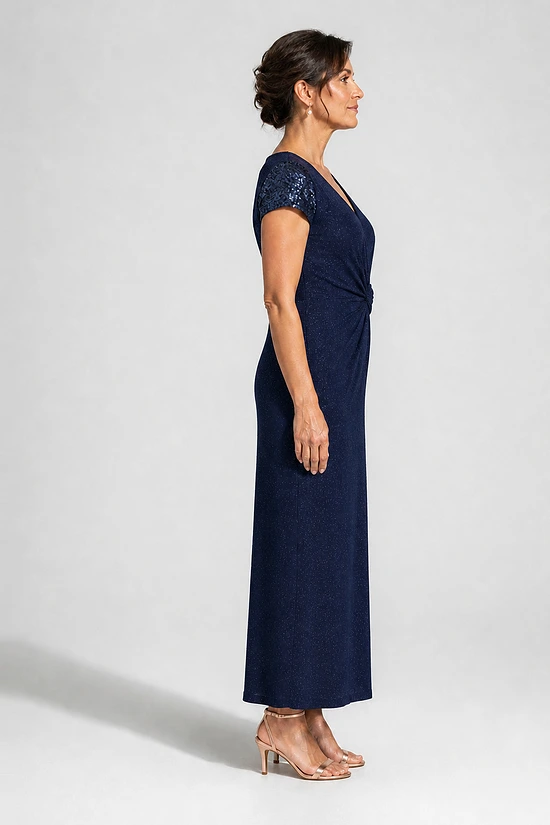 Side view of the Delphine navy twist-waist glitter knit gown by Dressology on a regular size model