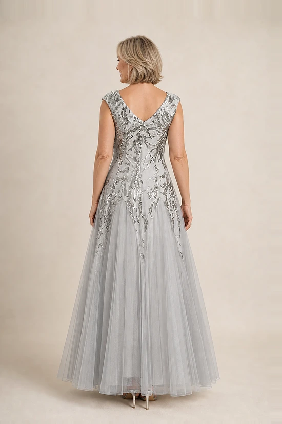 Back view of the silver glitter embroidered gown showing the V-shaped back and full tulle skirt