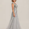 Side view of the silver glitter embroidered A-line gown showing the cap sleeve and tulle skirt