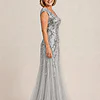 Side view of the silver glitter embroidered gown showing the cap sleeve and the soft trumpet tulle skirt, worn by a mother of the bride