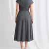 Back view of the charcoal beaded midi dress showing the crossover collar across the upper back and concealed centre back zip
