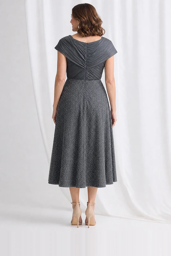 Back view of the charcoal beaded midi dress showing the crossover collar across the upper back and concealed centre back zip