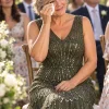 Illustrative garden wedding scene with a mother wearing the Celestine Olive Green gown by Dressology
