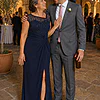 Mother of the groom wearing the navy Charlotte knotted crepe gown by Dressology, with her son at a sandstone courtyard reception