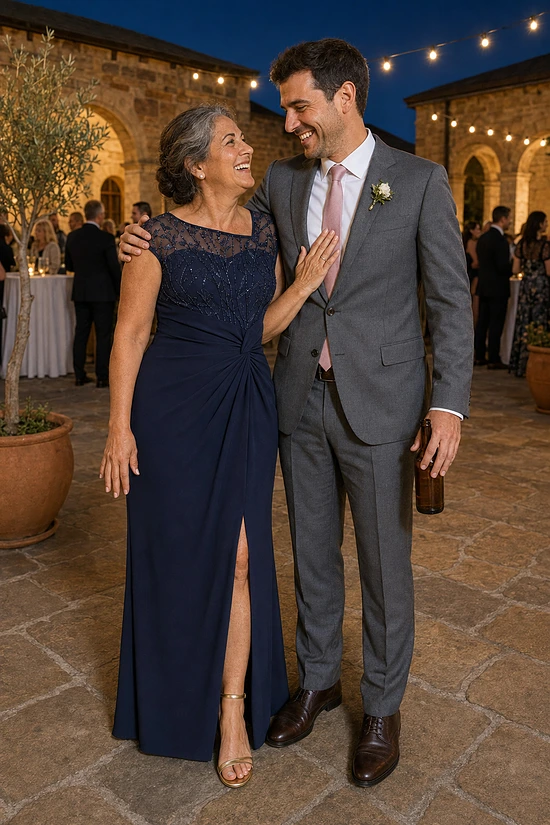 Mother of the groom wearing the navy Charlotte knotted crepe gown by Dressology, with her son at a sandstone courtyard reception