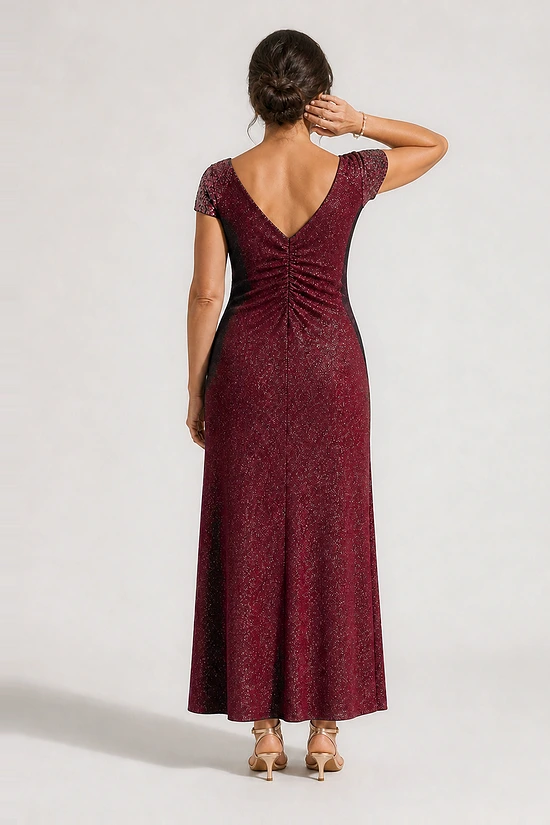 Back view of the Delphine burgundy twist-waist glitter knit gown by Dressology showing the V back and plain A-line skirt