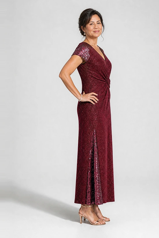 Delphine burgundy glitter knit gown side view showing the twist waist and sequin godet