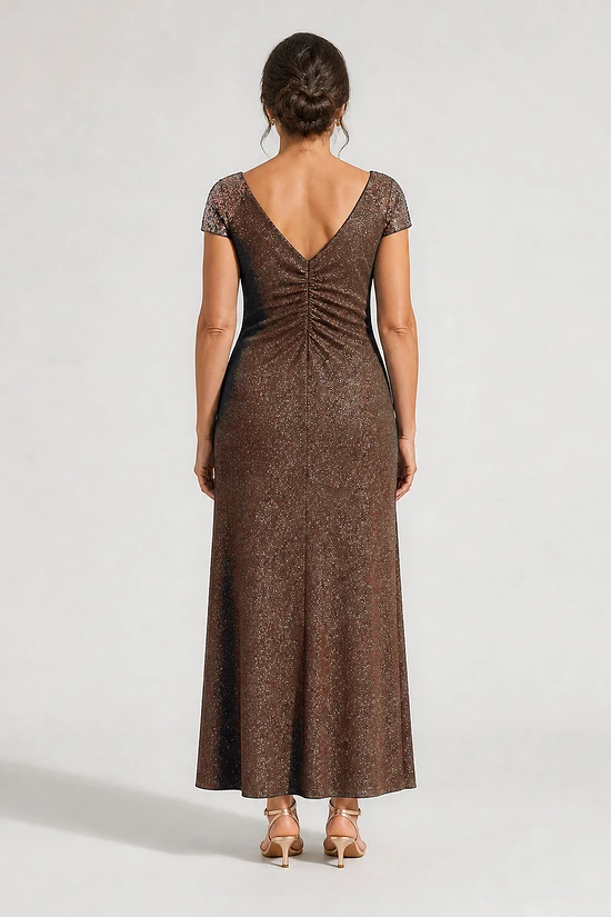Back view of the Delphine chocolate brown twist-waist glitter knit gown by Dressology on a regular size model showing the V back and A-line skirt