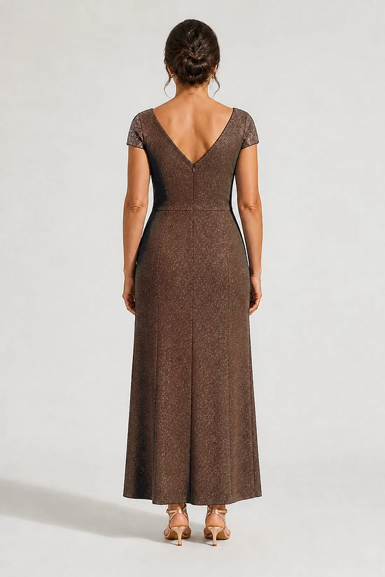 Back view of the Delphine chocolate brown twist-waist glitter knit gown by Dressology on a regular size model showing the V back and A-line skirt