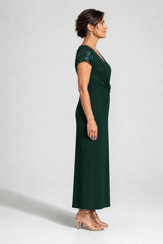 Side view of the Delphine emerald green twist-waist glitter knit gown by Dressology on a regular size model