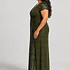 Side view of the Delphine olive green twist-waist glitter knit gown by Dressology on a plus size model