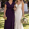 Mother of the bride wearing the purple Delphine glitter knit gown by Dressology, arm in arm with her daughter at the garden cocktail hour