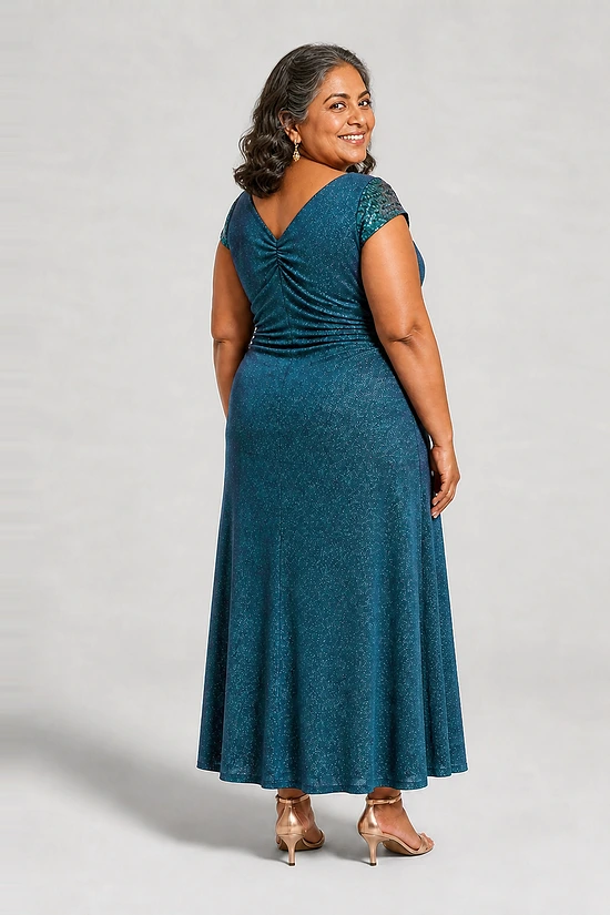 Back view of the Delphine teal twist-waist glitter knit gown by Dressology on a plus size model showing the V back and A-line skirt