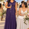 Mother with her adult child at a wedding, wearing the Sylvie Dark Purple gown by Dressology