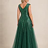 Back view of the emerald green glitter embroidered gown showing the V-shaped back and full tulle skirt