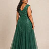 Back view of the emerald green glitter embroidered gown showing the V-shaped back and full tulle skirt, worn by a plus-size mother of the bride