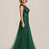 Side view of the emerald green glitter embroidered A-line gown showing the cap sleeve and tulle skirt