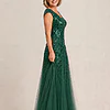 Side view of the emerald green glitter embroidered gown showing the cap sleeve and the soft trumpet tulle skirt, worn by a mother of the bride