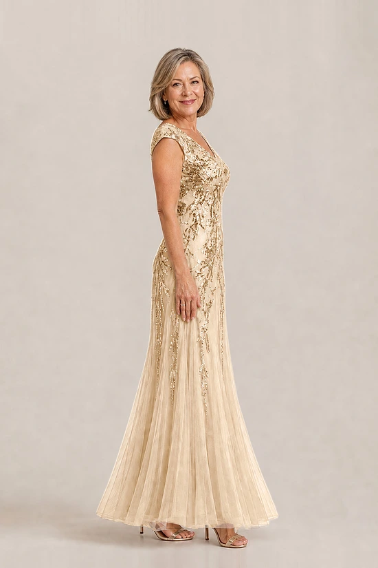 Side view of the champagne-gold Sylvie gown by Dressology with cap sleeves and soft trumpet tulle skirt