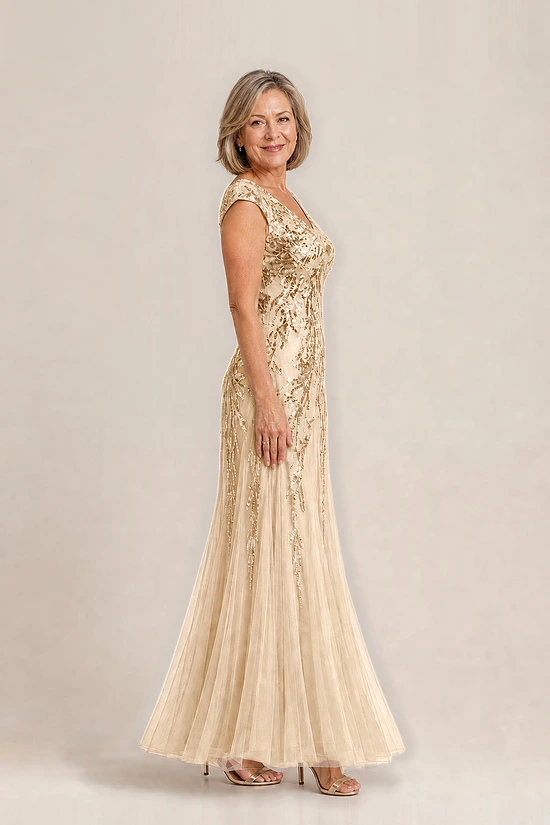 Side view of the champagne-gold Sylvie gown by Dressology with cap sleeves and soft trumpet tulle skirt