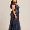 Side view of the navy glitter embroidered gown showing the cap sleeve and the soft trumpet tulle skirt, worn by a plus-size mother of the bride
