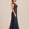 Side view of the navy glitter embroidered gown showing the cap sleeve and the soft trumpet tulle skirt, worn by a mother of the bride