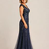 Side view of the navy glitter embroidered gown showing the cap sleeve and the soft trumpet tulle skirt, worn by a mother of the bride
