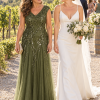 Mother with her adult child at a wedding, wearing the Sylvie Olive gown by Dressology